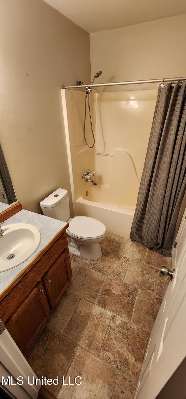 full bathroom featuring shower / bath combo, vanity, and toilet