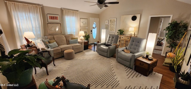 living room with ceiling fan, lofted ceiling, and light wood-type flooring