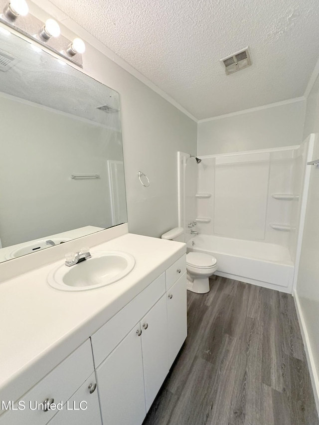 114 Leland St, Pearl, MS 39208 - bathroom featuring toilet, wood finished floors, crown molding, a textured ceiling, and visible vents