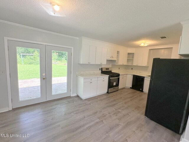114 Leland St, Pearl, MS 39208 - kitchen with french doors, a textured ceiling, under cabinet range hood, black appliances, and light countertops