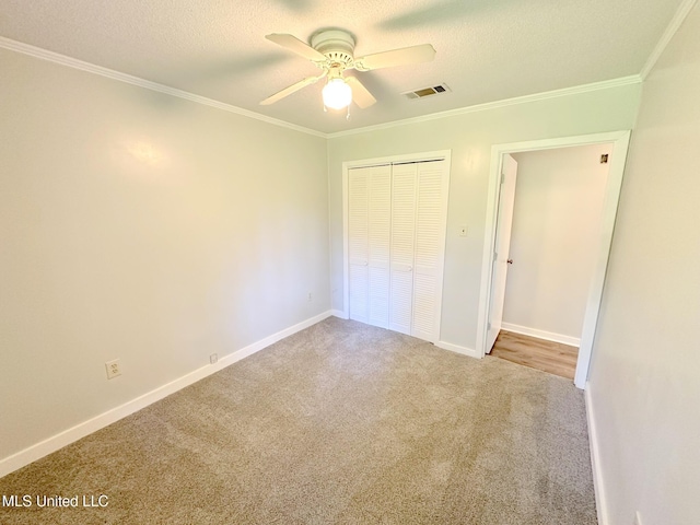 114 Leland St, Pearl, MS 39208 - unfurnished bedroom featuring a closet, visible vents, crown molding, carpet floors, and baseboards