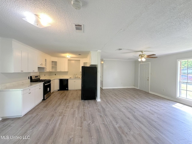 114 Leland St, Pearl, MS 39208 - kitchen with a textured ceiling, black appliances, and light wood-style floors