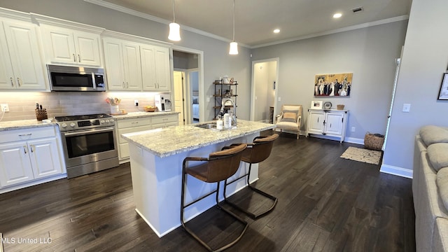 331 Emerald Way, Brandon, MS 39047 - kitchen with stainless steel appliances, a sink, white cabinets, backsplash, and dark wood finished floors