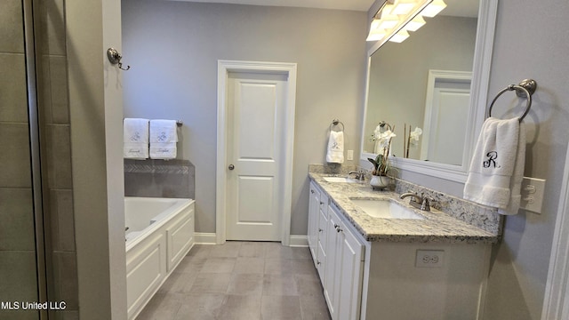 331 Emerald Way, Brandon, MS 39047 - full bath featuring double vanity, a garden tub, and baseboards