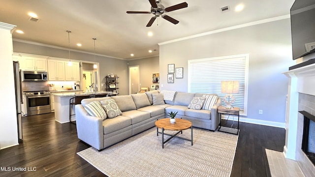 331 Emerald Way, Brandon, MS 39047 - living area with a fireplace, recessed lighting, a ceiling fan, dark wood-style floors, and crown molding