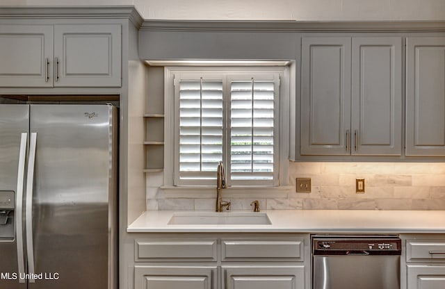 kitchen featuring backsplash, stainless steel appliances, and sink