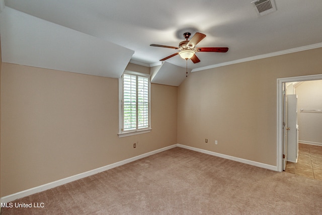 additional living space featuring light colored carpet, vaulted ceiling, and ceiling fan