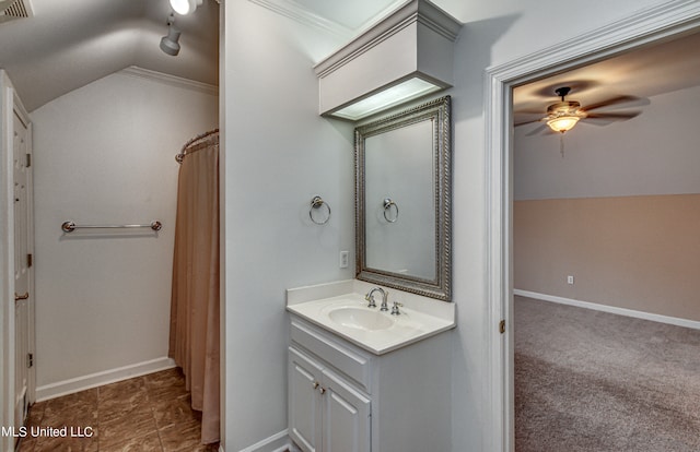 bathroom with vanity, ornamental molding, ceiling fan, and vaulted ceiling