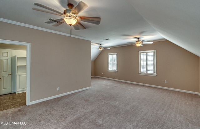 additional living space with ceiling fan, vaulted ceiling, and light colored carpet