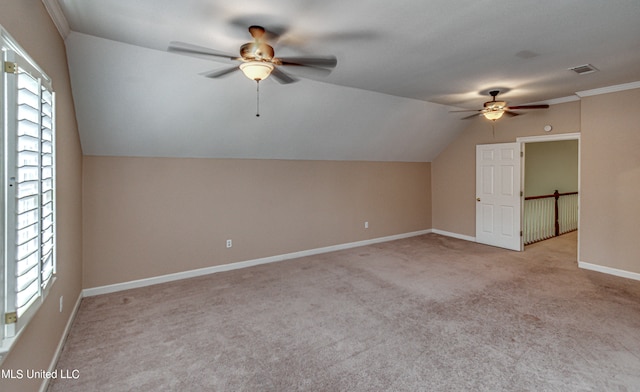 bonus room featuring light carpet, lofted ceiling, a healthy amount of sunlight, and ceiling fan