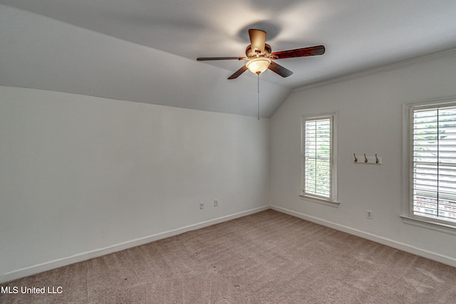 bonus room featuring lofted ceiling, carpet flooring, and plenty of natural light