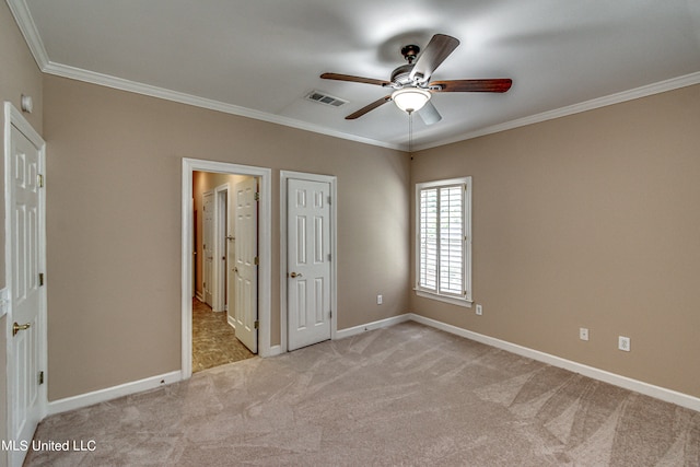 unfurnished bedroom featuring crown molding, light colored carpet, and ceiling fan