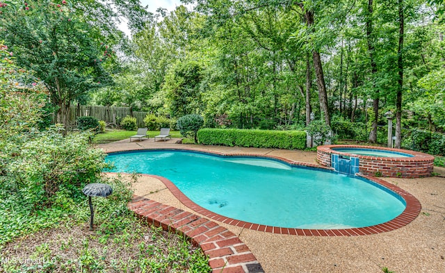 view of pool featuring an in ground hot tub