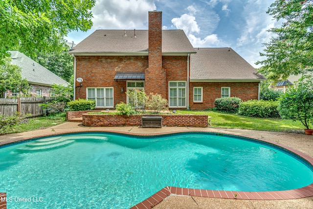 view of swimming pool featuring a patio area and a lawn