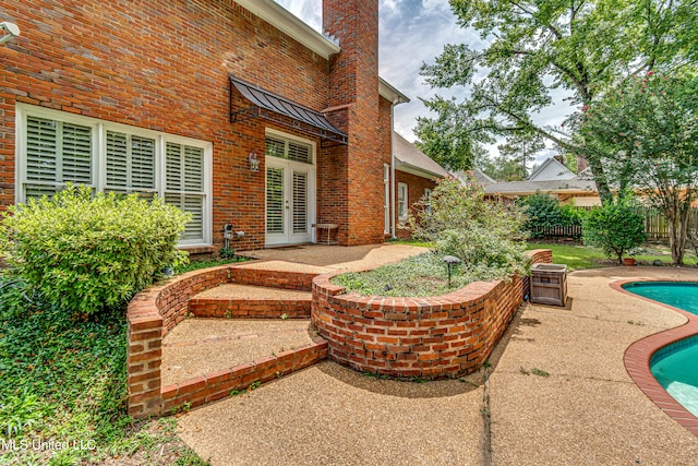 view of patio / terrace with a fenced in pool