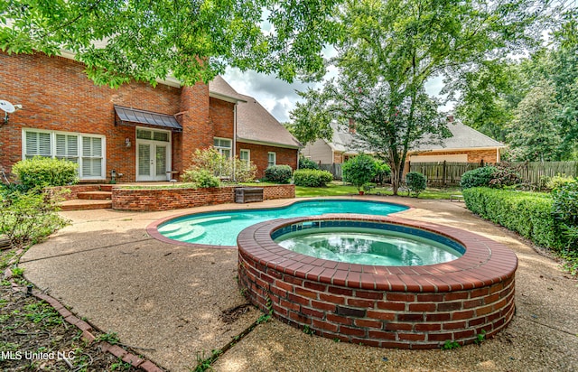 view of pool with an in ground hot tub and a patio