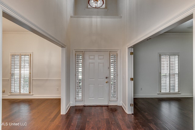 entryway featuring ornamental molding and dark hardwood / wood-style flooring