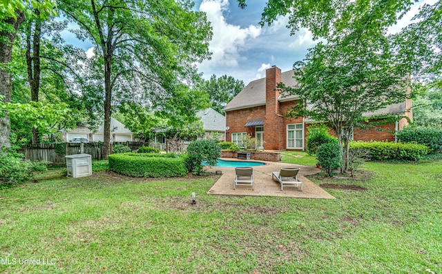 view of yard with a patio and a fenced in pool