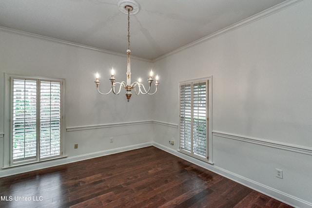 empty room featuring crown molding, dark hardwood / wood-style flooring, and a chandelier