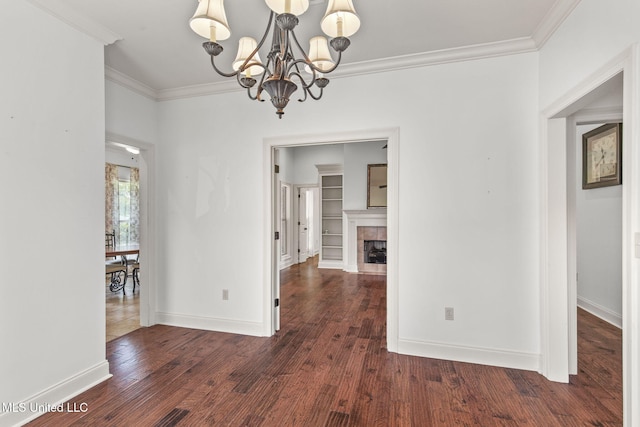 125 Rhodes Ln, Canton, MS 39046 - unfurnished dining area with a chandelier, crown molding, wood finished floors, baseboards, and a tile fireplace