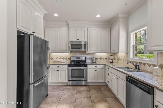 125 Rhodes Ln, Canton, MS 39046 - kitchen with appliances with stainless steel finishes, a sink, light stone countertops, tasteful backsplash, and white cabinets