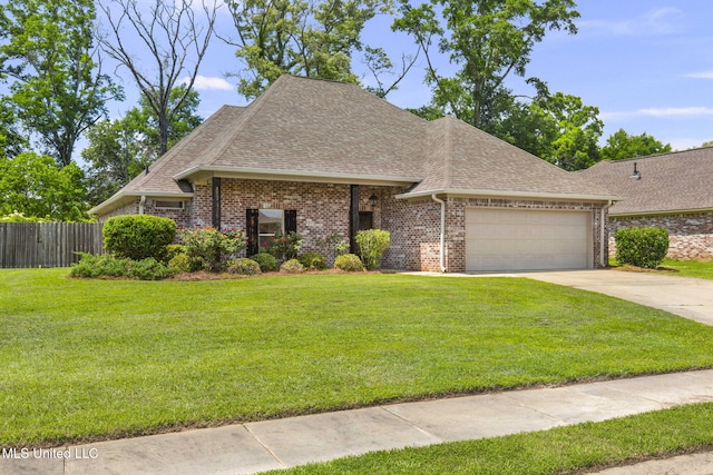 125 Rhodes Ln, Canton, MS 39046 - french provincial home featuring roof with shingles, an attached garage, driveway, and brick siding
