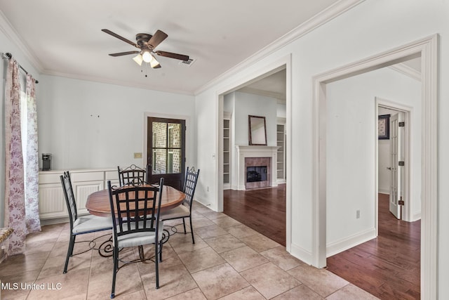 125 Rhodes Ln, Canton, MS 39046 - dining room featuring ceiling fan, crown molding, a tile fireplace, and baseboards