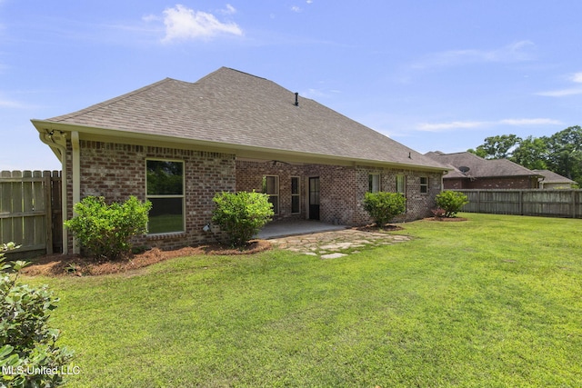 125 Rhodes Ln, Canton, MS 39046 - back of property with a shingled roof, brick siding, and a patio area