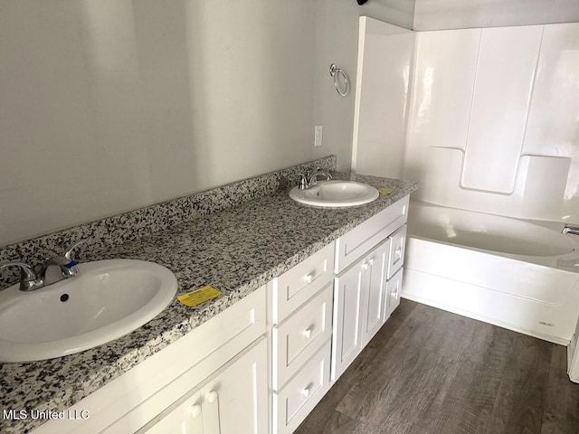 bathroom featuring vanity, a bathtub, and wood-type flooring