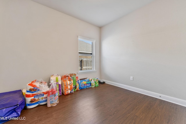 rec room featuring dark wood-style floors and baseboards