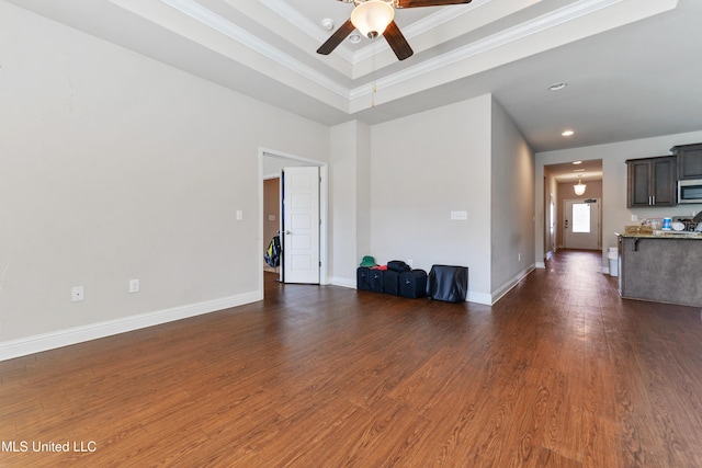 unfurnished living room featuring recessed lighting, dark wood finished floors, a ceiling fan, and baseboards