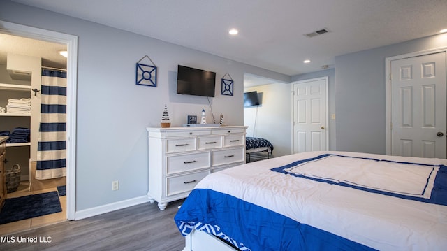 bedroom featuring dark hardwood / wood-style flooring and a closet