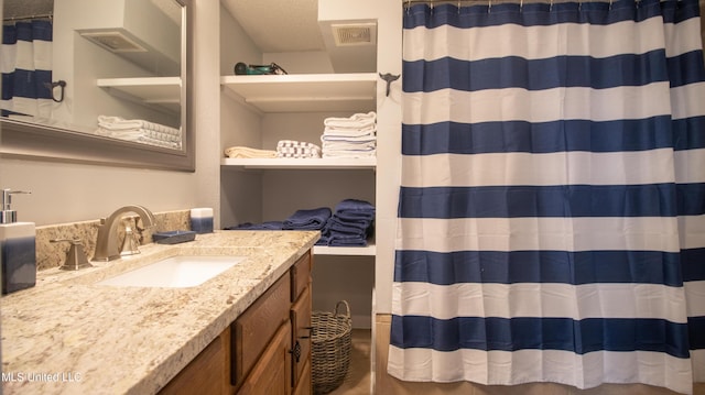 bathroom with vanity and a textured ceiling