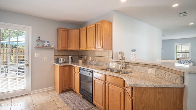 kitchen with sink, light tile patterned floors, black dishwasher, kitchen peninsula, and decorative backsplash