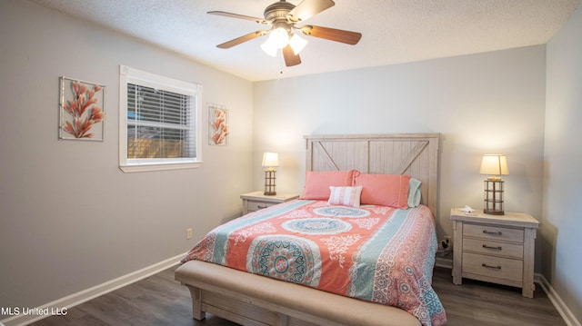 bedroom featuring dark hardwood / wood-style floors, a textured ceiling, and ceiling fan