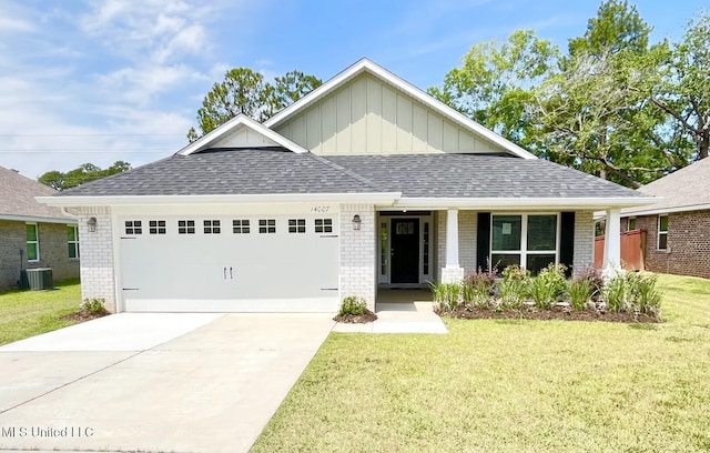 14007 Plantation Oaks Dr, Gulfport, MS 39503 - view of front of home with brick siding, a garage, a front lawn, and board and batten siding
