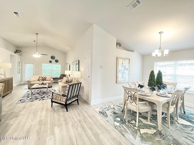 14007 Plantation Oaks Dr, Gulfport, MS 39503 - dining space with vaulted ceiling, healthy amount of natural light, a chandelier, and light wood-style floors