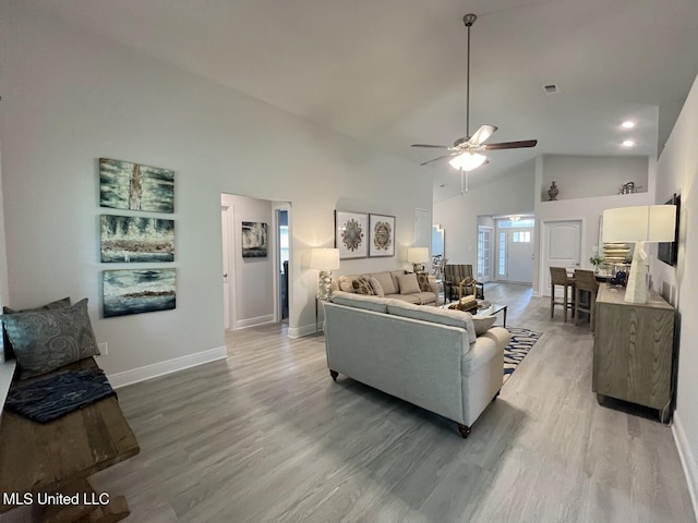 14007 Plantation Oaks Dr, Gulfport, MS 39503 - living room with light wood-style floors, baseboards, ceiling fan, and high vaulted ceiling