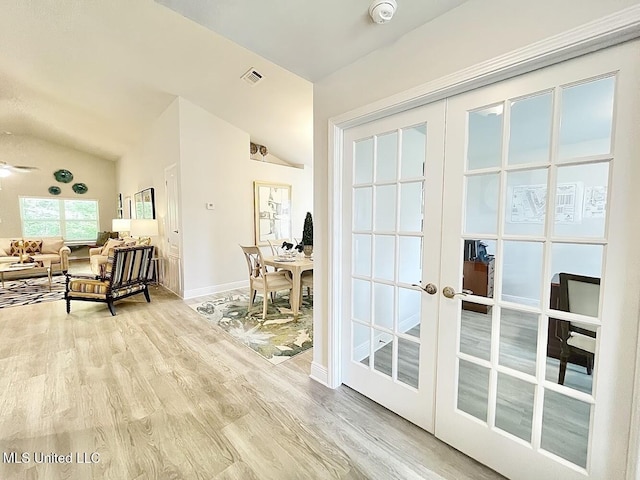 14007 Plantation Oaks Dr, Gulfport, MS 39503 - living room with french doors, lofted ceiling, light wood-style flooring, and baseboards