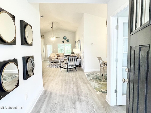 14007 Plantation Oaks Dr, Gulfport, MS 39503 - hall featuring lofted ceiling, wood finished floors, and baseboards