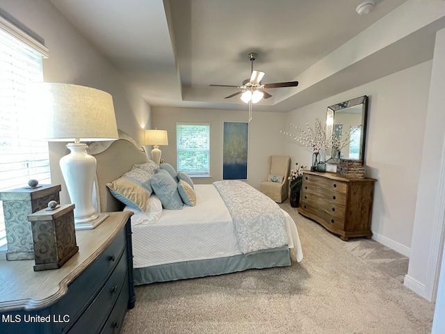 14007 Plantation Oaks Dr, Gulfport, MS 39503 - bedroom featuring light carpet, a raised ceiling, baseboards, and a ceiling fan