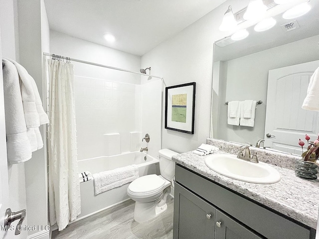 14007 Plantation Oaks Dr, Gulfport, MS 39503 - bathroom featuring wood finished floors, toilet, vanity, and shower / bath combo with shower curtain