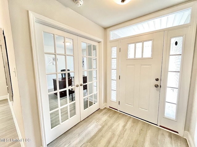 14007 Plantation Oaks Dr, Gulfport, MS 39503 - foyer featuring french doors, light wood finished floors, and healthy amount of natural light