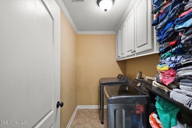 602 Oakview Way, Byram, MS 39272 - laundry area featuring washing machine and dryer, crown molding, a textured ceiling, cabinet space, and baseboards