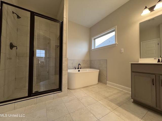 full bathroom featuring tile walls, visible vents, vanity, a shower stall, and a freestanding tub