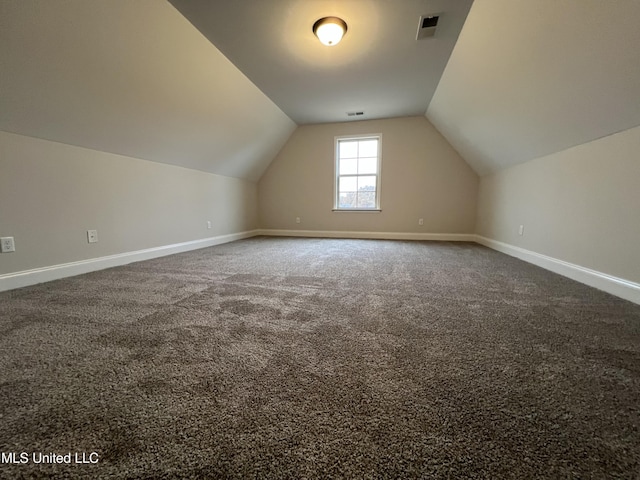 bonus room with lofted ceiling, carpet floors, baseboards, and visible vents