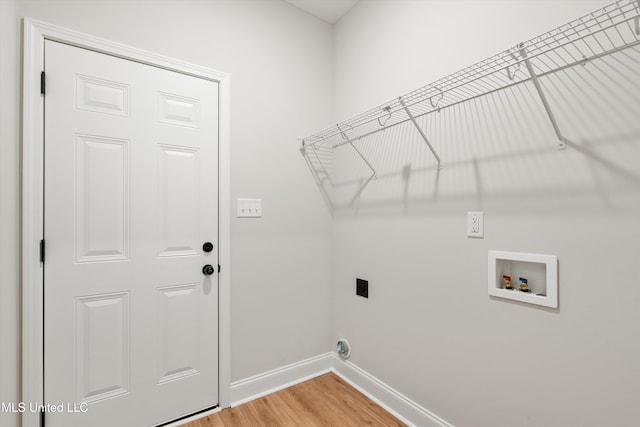 laundry room featuring laundry area, baseboards, wood finished floors, washer hookup, and electric dryer hookup