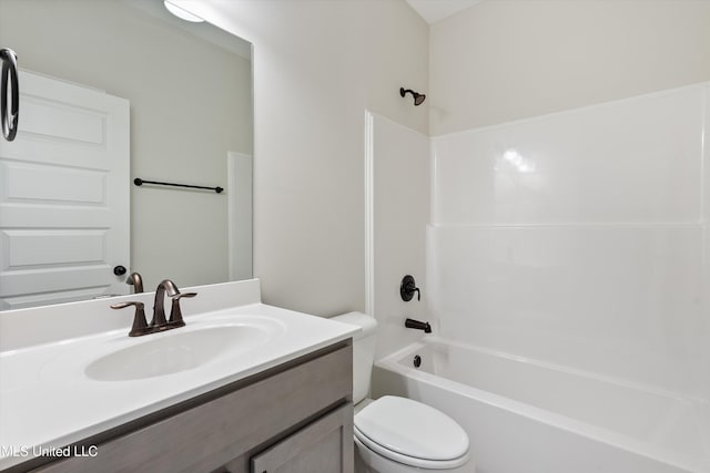 bathroom featuring toilet, bathtub / shower combination, and vanity