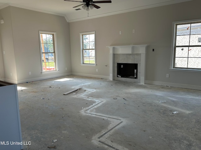 unfurnished living room featuring baseboards, a ceiling fan, a tiled fireplace, ornamental molding, and vaulted ceiling