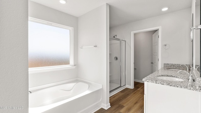 9613 Reserve Blvd, Biloxi, MS 39532 - bathroom featuring a garden tub, a shower stall, wood finished floors, double vanity, and recessed lighting